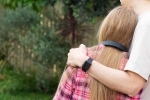 Father hugs teenage daughter. Parents and teens relationship concept